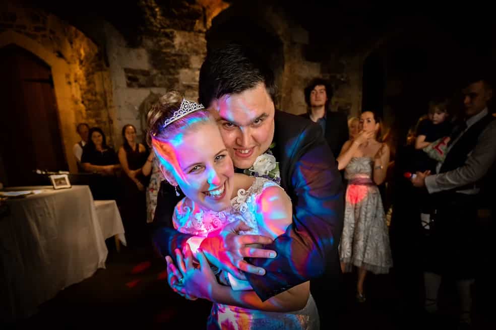 Groom Holding Bride During Dancing at St Ethelreda's Church in London